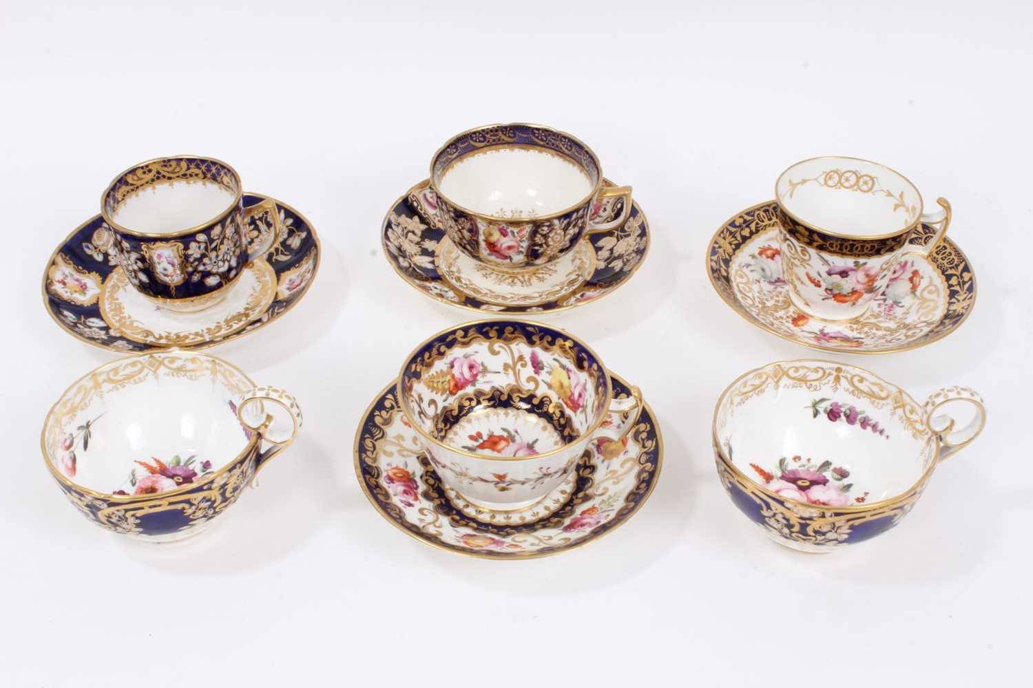 Lot 313 - Early 19th century Coalport tea wares, with polychrome floral decoration on gilt patterned grounds, some pieces moulding, including four matching cups and saucers and two further matching cups (10)