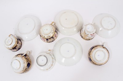 Lot 313 - Early 19th century Coalport tea wares, with polychrome floral decoration on gilt patterned grounds, some pieces moulding, including four matching cups and saucers and two further matching cups (10)
