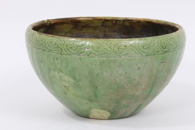 Lot 324 - Two early Chinese green / celadon glazed bowls, one with a ribbed body, the other with incised pattern around the rim, 12cm and 13cm diameter