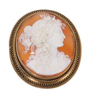 Lot 720 - 19th century Italian carved shell cameo brooch depicting a classical female bust wearing flowers in her hair, mounted in an oval gold brooch mount with applied filigree border, 51mm x 4mm.