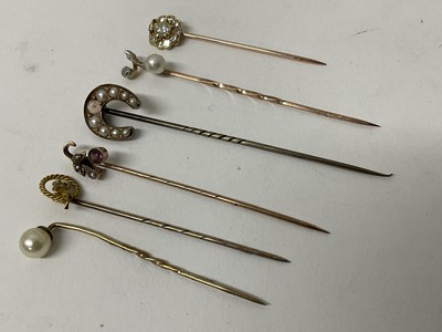 Lot 732 - Six antique stick pins to include a diamond cluster stick pin