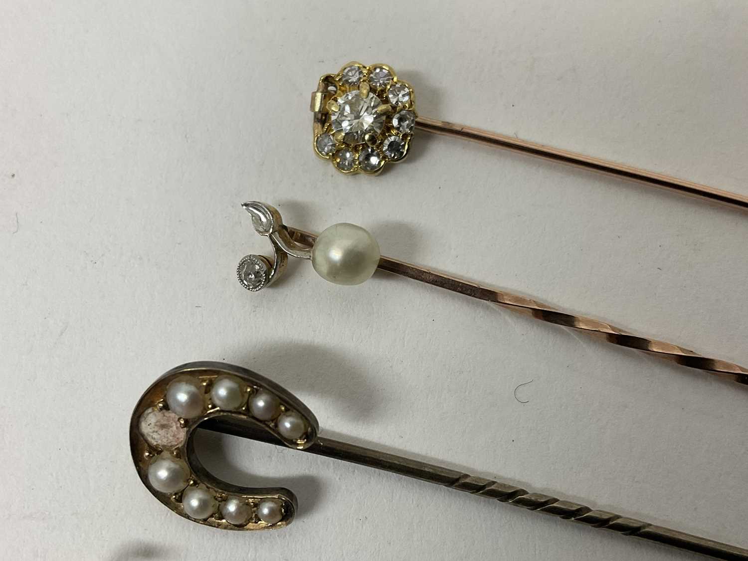 Lot 732 - Six antique stick pins to include a diamond