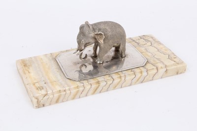 Lot 1068 - Fossilised mammoth tooth paperweight, mounted with a silver model of an elephant