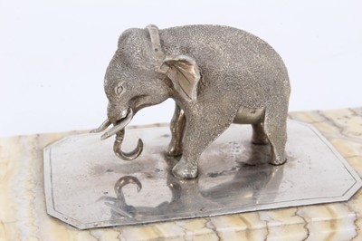 Lot 1068 - Fossilised mammoth tooth paperweight, mounted with a silver model of an elephant