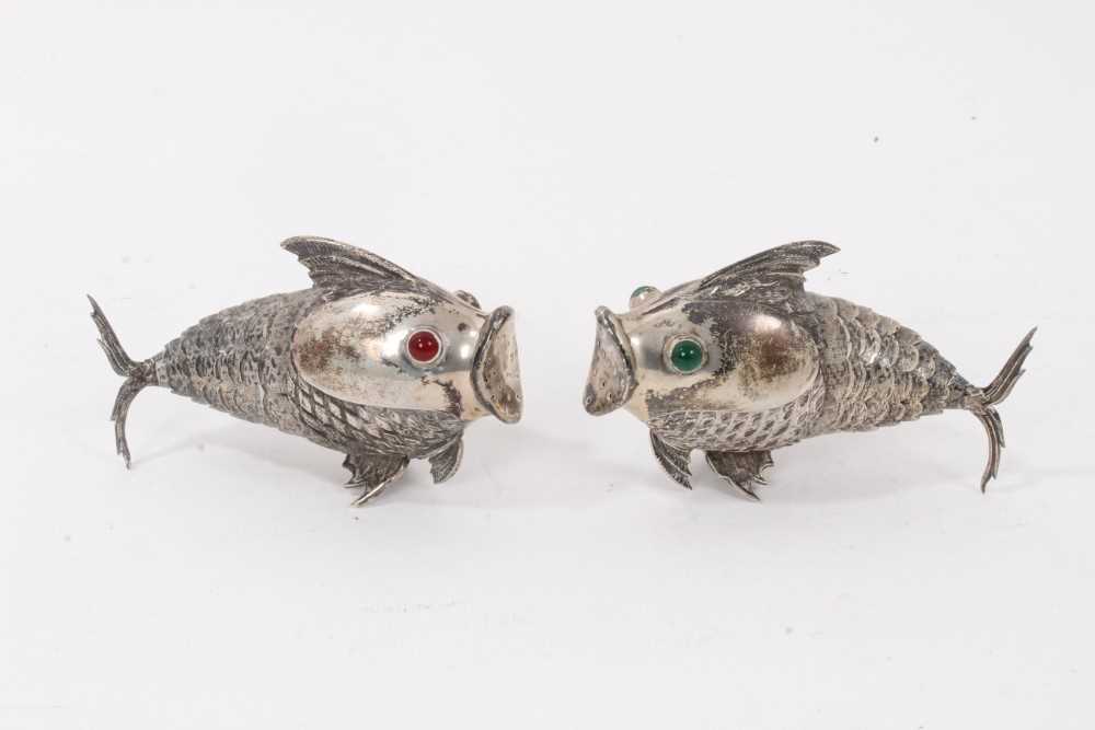 Lot 538 - Pair of Spanish silver articulated fish pepperettes set with red and green cabochon eyes, marked under fins, each 9.5cm in length.