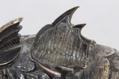 Lot 538 - Pair of Spanish silver articulated fish pepperettes set with red and green cabochon eyes, marked under fins, each 9.5cm in length.