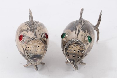 Lot 538 - Pair of Spanish silver articulated fish pepperettes set with red and green cabochon eyes, marked under fins, each 9.5cm in length.