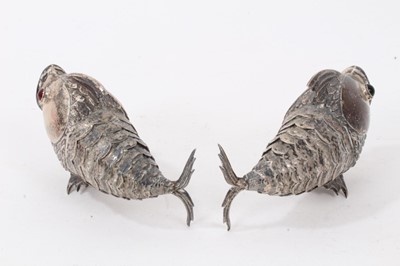 Lot 538 - Pair of Spanish silver articulated fish pepperettes set with red and green cabochon eyes, marked under fins, each 9.5cm in length.