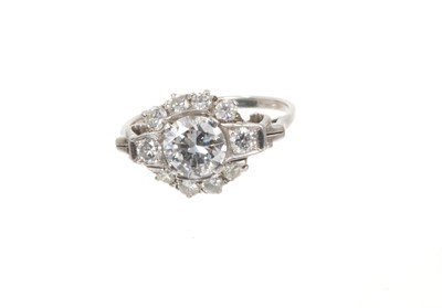 Lot 698 - Art Deco diamond ring, the cluster with a central transitional old cut diamond estimated to weigh approximately 1.17cts flanked by further old brilliant cut diamonds with scroll shoulders on platin...