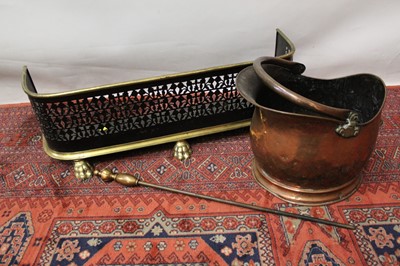 Lot 1490 - 19th century brass and pierced steel fender  fender, copper coal scuttle and a poker