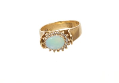 Lot 766 - Opal and diamond cluster ring with an oval cabochon opal surrounded by a border of brilliant cut diamonds in 18ct gold setting, Sheffield 1994. Ring size J½.