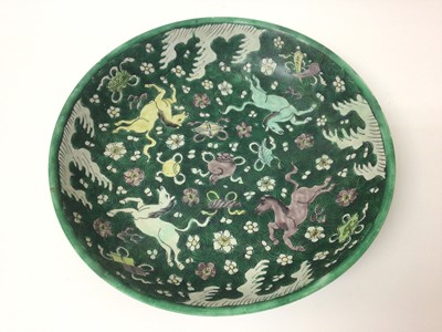 Lot 372 - Antique Chinese Qing famille verte porcelain dish painted with horses, precious objects, waves and scrolls, 33cm diameter