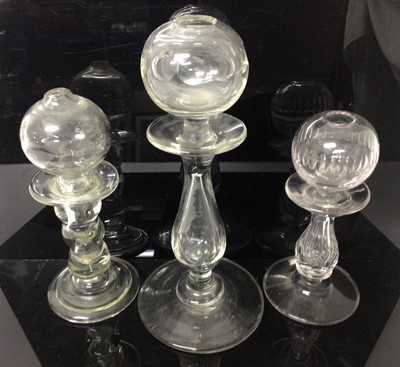 Lot 373 - Three 18th/19th century glass lacemaker's lamps, two with cut decoration