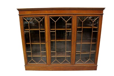 Lot 1485 - Edwardian mahogany and satinwood cross banded floor standing bookcase, with Greek key cornice and adjustable shelves enclosed by three astragal glazed doors on plinth base, 185cm wide x 31cm deep x...