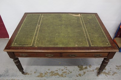 Lot 1494 - Edwardian oak library table, with inset tooled leather top and two frieze drawers to each side on reeded supports and castors, 151cm wide x 106cm deep x 78cm high