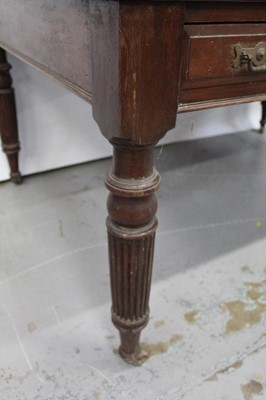 Lot 71 - Edwardian oak library table, with inset tooled leather top and two frieze drawers to each side on reeded supports and castors, 151cm wide x 106cm deep x 78cm high