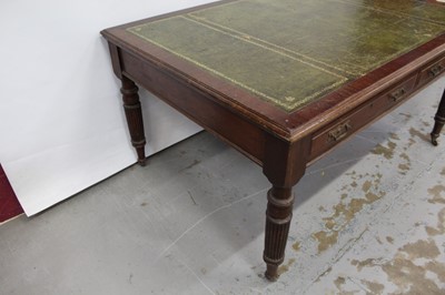Lot 71 - Edwardian oak library table, with inset tooled leather top and two frieze drawers to each side on reeded supports and castors, 151cm wide x 106cm deep x 78cm high