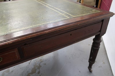 Lot 71 - Edwardian oak library table, with inset tooled leather top and two frieze drawers to each side on reeded supports and castors, 151cm wide x 106cm deep x 78cm high