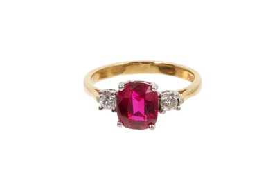 Lot 798 - Diamond and synthetic ruby three stone ring epeith a central mixed cut synthetic ruby flanked by two round brilliant cut diamonds estimated to weigh approximately 0.16cts in total, in claw setting...