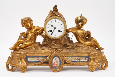 Lot 886 - 19th century French gilt brass mantel clock with inset porcelain panels, twin putti mounts and central white enamel dial