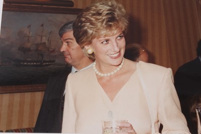 Lot 150 - Diana, Princess of Wales, five amusing informal photographs of Diana at a cocktail party