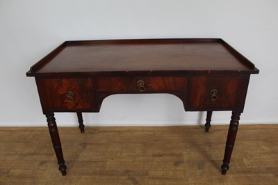 Lot 1502 - Regency mahogany dressing table, with galleried top and three drawers to the shaped frieze on ring turned legs, 123cm wide x 63cm deep x 80cm high