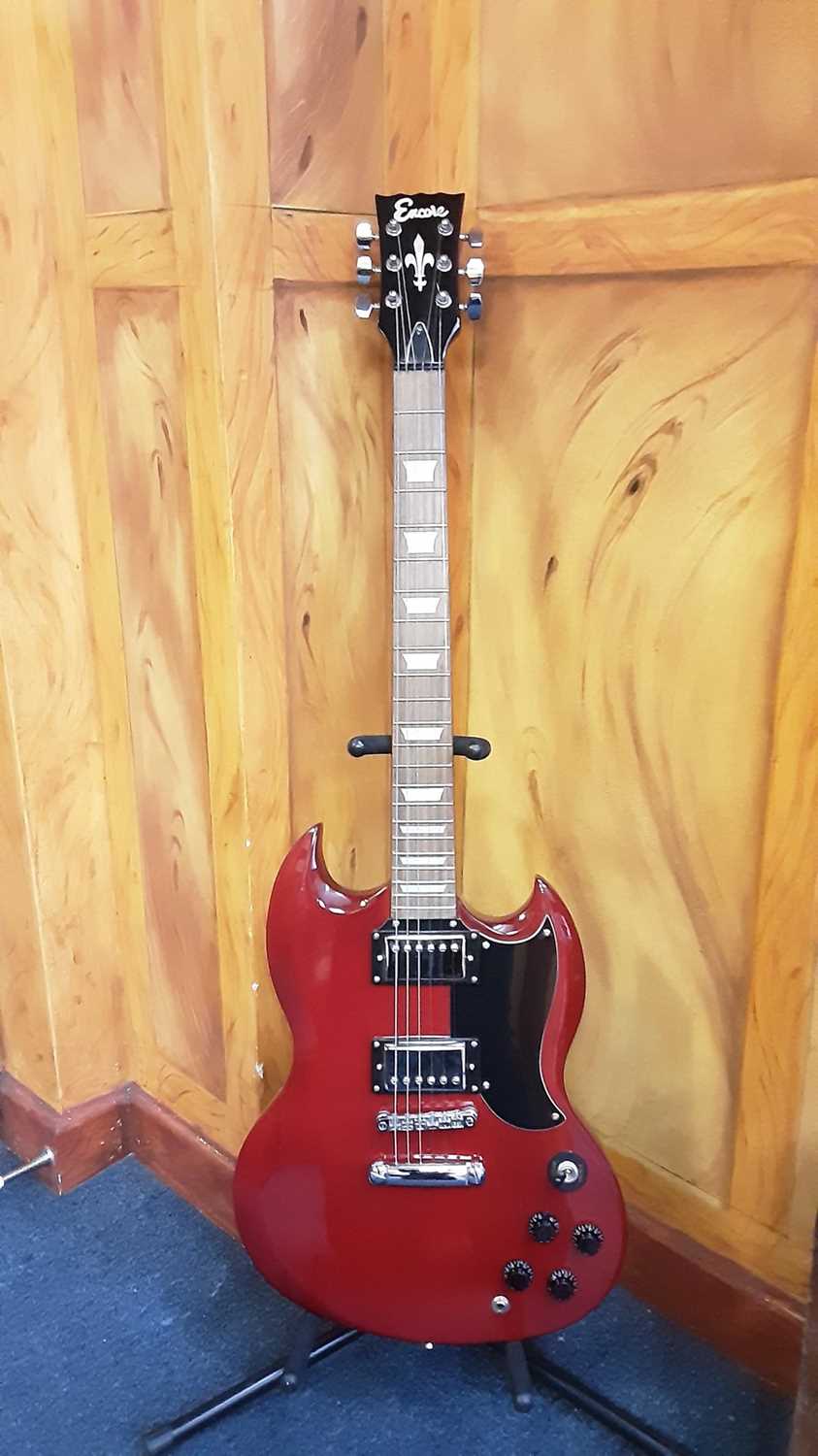 Lot 2250 - Red Encore electric guitar (immaculate) with strap plus Kingsman gigging bag, guitar stand, Kingsman Amp and small metal seat