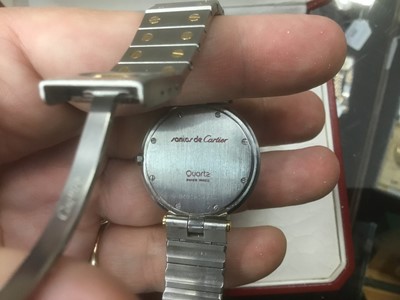 Lot 585 - Cartier Santos de Cartier wristwatch with white enamel dial, black enamel Roman numerals, blued steel hands, quartz movement, in circular stainless steel 32mm case, on a bi-metal bracelet with depl...