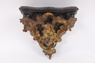 Lot 1064 - A 19th century French ormolu and ebonised wood wall bracket, showing a horse surrounded by scrollwork ornamentation, 27cm wide x 24cm high