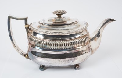 Lot 557 - George III silver teapot of compressed baluster form, with band of fluted decoration and gadrooned borders, hinged domed cover, with fluted finial and handle with ivory insulators, (London 1815) ma...