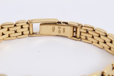 Lot 573 - Ladies Longines 18ct gold wristwatch with rectangular tank shape case with gold dial and applied gold Roman numerals and dot hour markers,  quartz movement in gold case on 18ct gold bracelet, in bo...