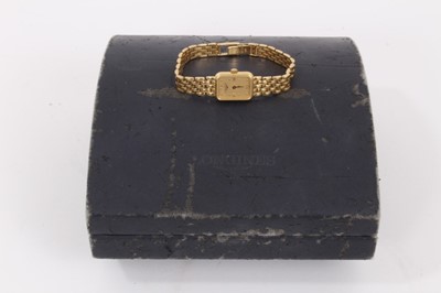 Lot 573 - Ladies Longines 18ct gold wristwatch with rectangular tank shape case with gold dial and applied gold Roman numerals and dot hour markers,  quartz movement in gold case on 18ct gold bracelet, in bo...