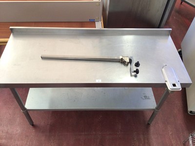 Lot 48 - A wall mounted stainless steel preparation bench, with shelf under and fitted can opener, 1500 mm