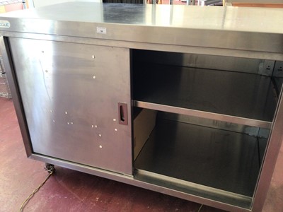 Lot 56 - A stainless steel freestanding cabinet, with two sliding doors, on castors, 1200 mm