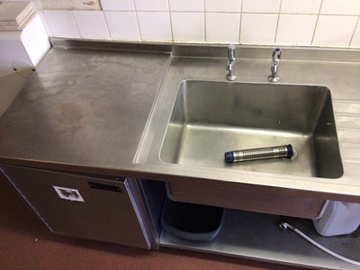Lot 57 - A stainless steel single bowl sink unit, with two taps, integral cabinet and shelf under, 1800 mm
