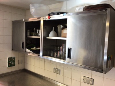 Lot 59 - A Moffat twin sliding door stainless steel wall cupboard, 600 mm together with two similar wall cabinets, each 900 mm