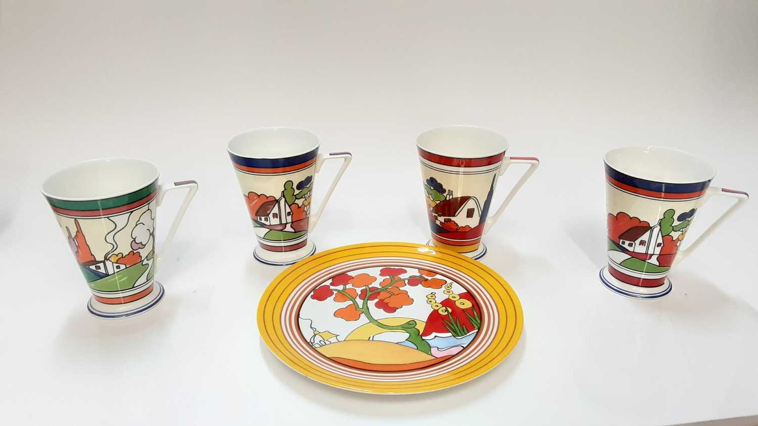 Lot 1222 - Wedgwood Bridgewater pattern Clarice Cliff style plate together with nine Wren Daydream mugs and four Wren Home Sweet Home mugs