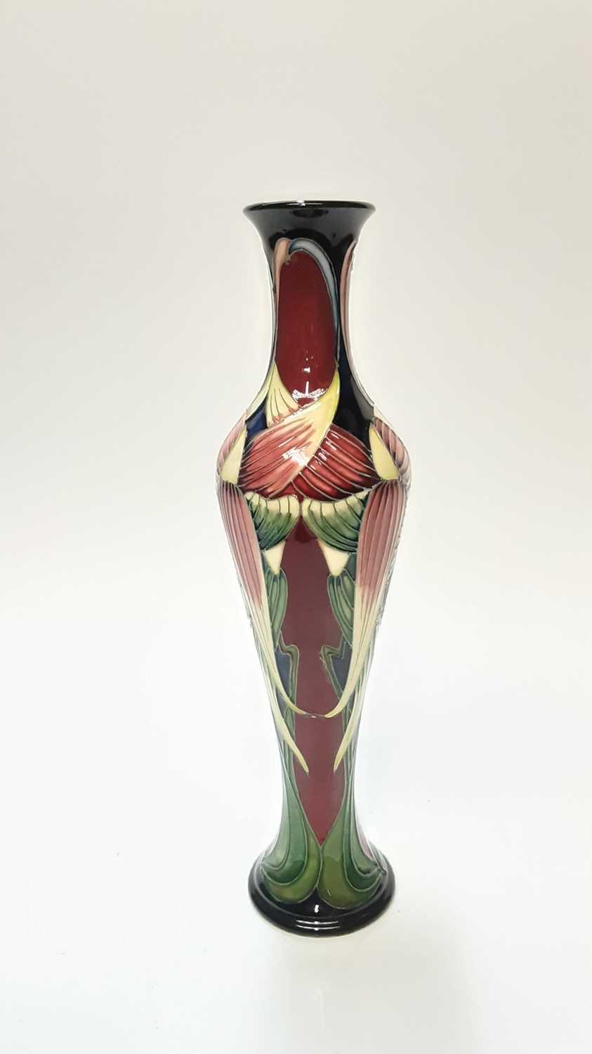 Lot 1224 - Moorcroft pottery vase decorated in the Trinity pattern, signed Phillip Gibson, numbered 328, dated 2003, 31.5cm high, boxed