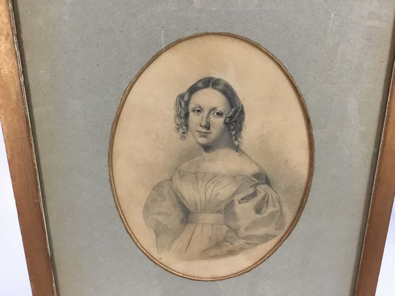 Lot 45 - Manner of Sir George Richmond pencil on paper - Portrait of a young lady of the 1820's, in oval mount, in glazed gilt frame
