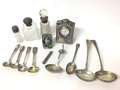 Lot 262 - Silver mounted bedside clock, silver mounted glass scent bottles, silver salt spoons and other items