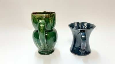 Lot 1283 - Farnham pottery green owl jug by Harris 17 cm and another blue owl jug 11cm (2)