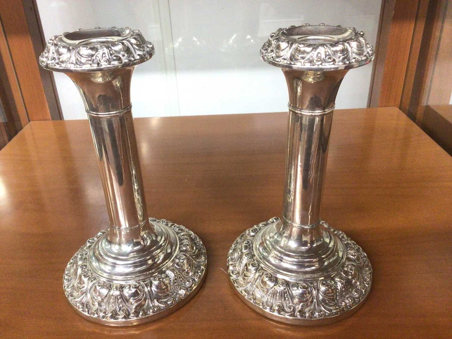 Lot 811 - Pair of Edwardian silver candlesticks