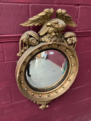 Lot 1322 - Regency gilt convex wall mirror with eagle cresting