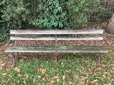 Lot 1336 - Set of three very long antique slatted and cast iron benches, on scrolled supports, 245cm long