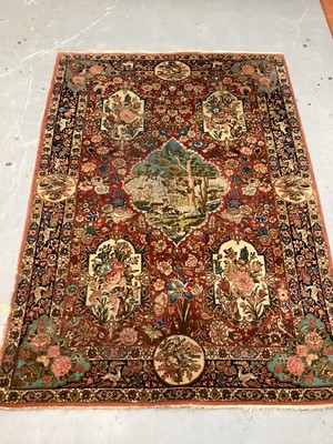 Lot 1548 - Fine quality Tabriz pictoral rug, with foliate and landscape reserves and meandering foliage on brick red grounds conforming borders