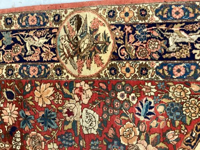 Lot 1548 - Fine quality Tabriz pictoral rug, with foliate and landscape reserves and meandering foliage on brick red grounds conforming borders