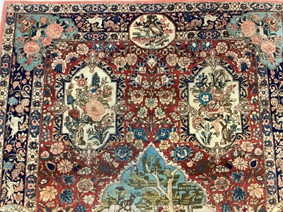 Lot 1548 - Fine quality Tabriz pictoral rug, with foliate and landscape reserves and meandering foliage on brick red grounds conforming borders