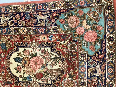 Lot 1548 - Fine quality Tabriz pictoral rug, with foliate and landscape reserves and meandering foliage on brick red grounds conforming borders