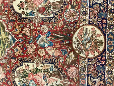 Lot 1548 - Fine quality Tabriz pictoral rug, with foliate and landscape reserves and meandering foliage on brick red grounds conforming borders