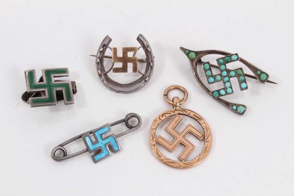 Lot 292 - 9ct gold swastika pendant together with four silver swastika brooches (5)